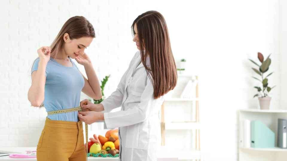 Doctor helping in weight loss